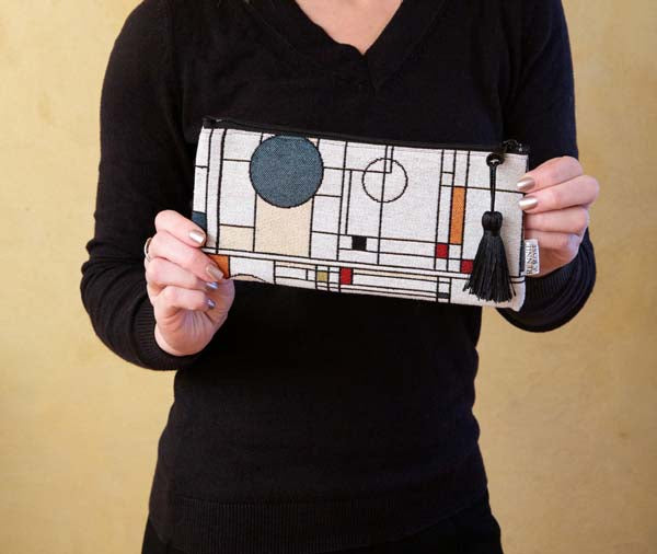 Circle Study accessory pouch in rich jacquard fabric with zipper and tassel pull.