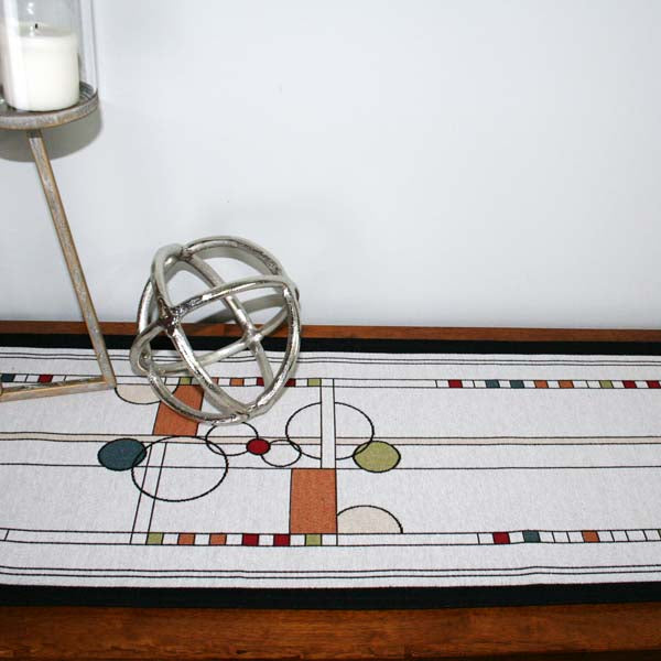 This unique design draws inspiration from the art of Calder and the beauty of contemporary stained-glass windows. A background of varied squares and rectangles forms an intricate grid, layered with scattered circles to create a sense of depth and movement. Carefully chosen colors reflect one of our favorite architectural elements—a timeless stained-glass window—bringing warmth and vibrancy to any space.